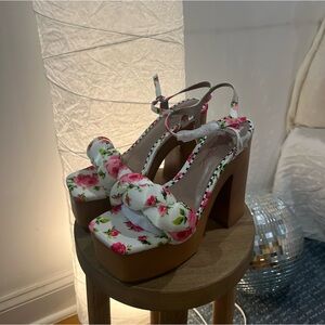MANDEE BETSEY JOHNSON floral print platform heel with a twisted toe strap.